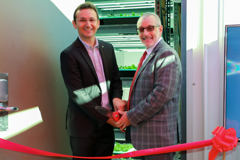 Associate Professor Rhuanito Ferrarezi (left) and CAES Dean Nick Place prepare for the vertical farm ribbon cutting on Oct. 4. (Photo by Jordan Powers)